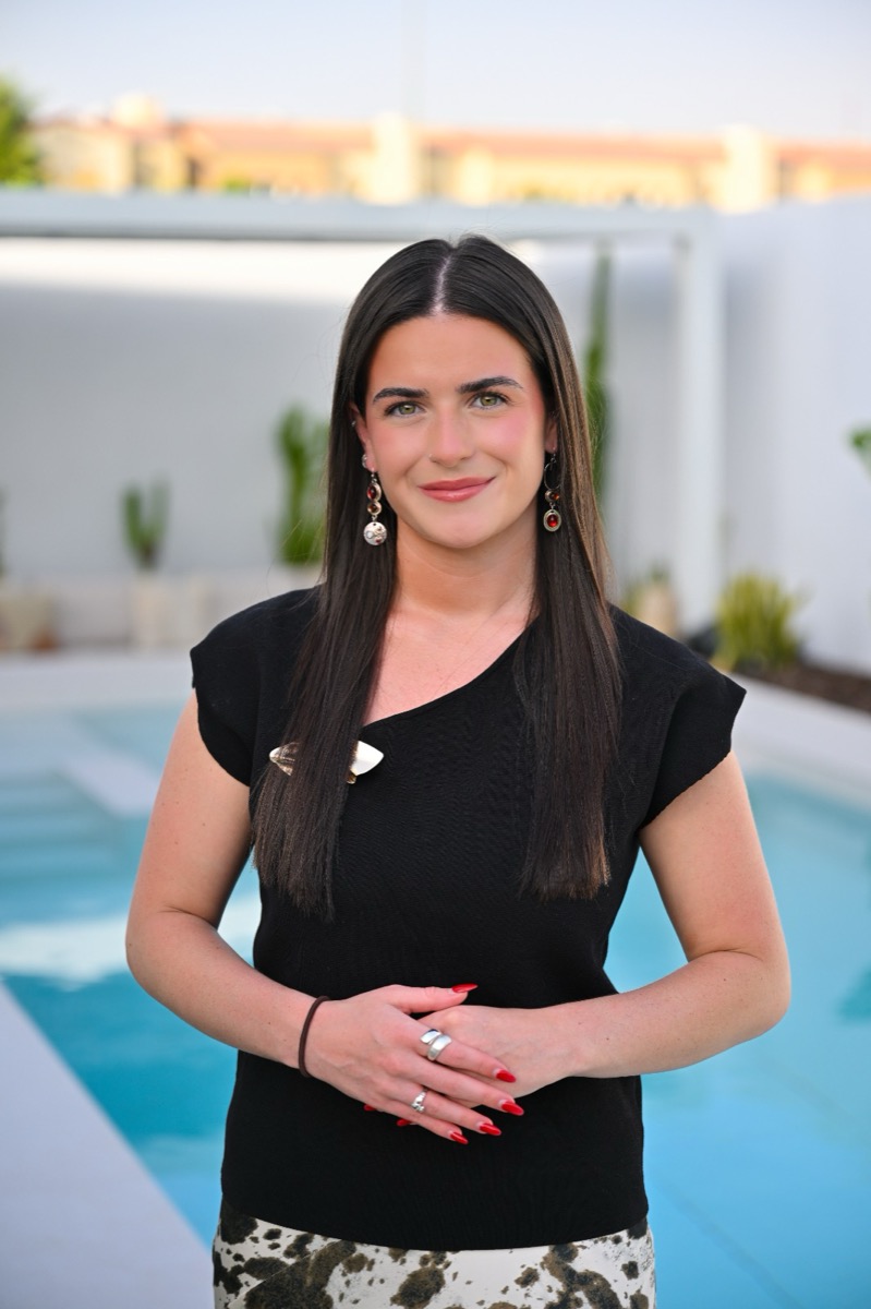 Shauna McGuinness, founder of McWellness, standing confidently in a bright outdoor setting